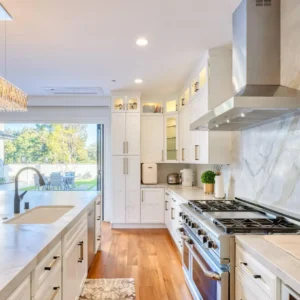 A kitchen being professionally cleaned—countertops shining, stainless-steel appliances spotless, decorated with subtle holiday touches.