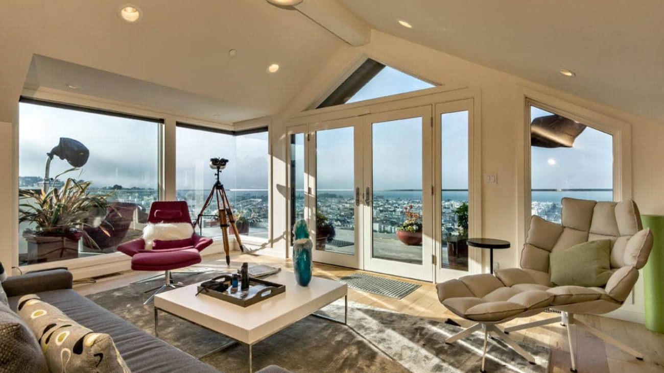 A bright, freshly cleaned San Francisco living room with soft winter light coming through large windows and a calm, modern feel.