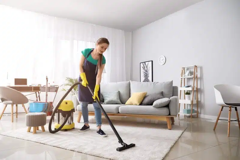 vacuuming rug in San Francisco living room to reduce dust